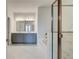Bright bathroom featuring double vanity, large mirrors, marble floors, soaking tub and glass enclosed shower at 4041 Andover Cir, Mcdonough, GA 30252
