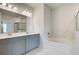 Spacious bathroom featuring double sink vanity, large mirror, white counter tops and separate tub at 4041 Andover Cir, Mcdonough, GA 30252