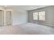 Bedroom with plush carpeting, two large windows that bring in natural light, and neutral paint color at 4041 Andover Cir, Mcdonough, GA 30252