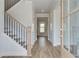 Bright and airy entryway featuring wood floors, staircase, and stylish front door at 4041 Andover Cir, Mcdonough, GA 30252