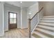 Welcoming entryway with wood-look flooring and staircase, showcasing a stylish interior at 4041 Andover Cir, Mcdonough, GA 30252