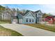Beautiful blue home with attached garage and a well-maintained front lawn at 4041 Andover Cir, Mcdonough, GA 30252
