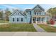 Inviting two-story home featuring a quaint front porch and professionally landscaped yard at 4041 Andover Cir, Mcdonough, GA 30252