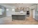 A spacious kitchen features gray cabinets, stainless appliances, and a large island with pendant lighting at 4041 Andover Cir, Mcdonough, GA 30252