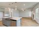 A spacious kitchen features gray cabinets, stainless appliances, and a farmhouse sink on the island at 4041 Andover Cir, Mcdonough, GA 30252