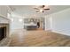 Open living room with hardwood floors, fireplace, and adjacent kitchen at 4041 Andover Cir, Mcdonough, GA 30252