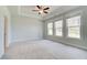 Large main bedroom with tray ceiling, neutral paint, and large windows overlooking the backyard at 4041 Andover Cir, Mcdonough, GA 30252