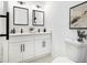 Bright bathroom with dual vanity, black hardware, and stylish decor for a modern and clean aesthetic at 580 Hutchens Se Rd, Atlanta, GA 30354