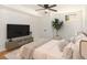 Comfortable bedroom with ceiling fan, large TV, neutral tones, and bright natural light at 580 Hutchens Se Rd, Atlanta, GA 30354