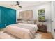 Relaxing bedroom with modern ceiling fan, hardwood floors, decorative blue accent wall, and natural light at 580 Hutchens Se Rd, Atlanta, GA 30354