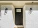 Welcoming front door with stylish black hardware and elegant exterior lighting fixtures at 580 Hutchens Se Rd, Atlanta, GA 30354