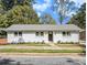 A well-maintained single-story home with freshly painted brick, a cozy walkway, and lush landscaping at 580 Hutchens Se Rd, Atlanta, GA 30354