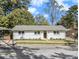 Single-story home boasts manicured landscaping, freshly painted brick, and a neatly paved walkway to the entrance at 580 Hutchens Se Rd, Atlanta, GA 30354