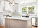 Bright kitchen with white cabinets, modern appliances, and quartz countertops with a black sink and gold fixtures at 580 Hutchens Se Rd, Atlanta, GA 30354