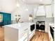 Modern kitchen features a spacious island, stainless steel appliances and white cabinetry with gold hardware at 580 Hutchens Se Rd, Atlanta, GA 30354