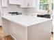 Close up on modern waterfall-style kitchen island with quartz countertops and a stainless steel faucet and sink at 580 Hutchens Se Rd, Atlanta, GA 30354