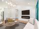 Bright living room features hardwood floors, fireplace, tv, accent wall, and lots of natural light at 580 Hutchens Se Rd, Atlanta, GA 30354
