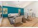 Bright living room with hardwood floors, accent wall, neutral furniture, and natural light from large windows at 580 Hutchens Se Rd, Atlanta, GA 30354