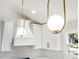 Stylish kitchen featuring modern pendant lights, white cabinets, and updated fixtures at 580 Hutchens Se Rd, Atlanta, GA 30354