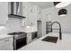 A modern kitchen with white cabinets, stainless steel appliances, and a center island with sink at 2200 Carlton Ct # 6, Atlanta, GA 30318