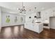 A bright kitchen featuring white cabinetry, a large island, and modern pendant lighting at 2200 Carlton Ct # 6, Atlanta, GA 30318