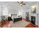 Spacious bedroom with hardwood floors, a fireplace, and a tray ceiling at 2580 Defoors Ferry Nw Rd, Atlanta, GA 30318