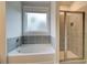 Well-appointed bathroom featuring a soaking tub, separate shower, and neutral tones for a clean, modern aesthetic at 4045 Andover Cir, Mcdonough, GA 30252