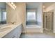 Elegant bathroom features a double vanity, soaking tub, and glass-enclosed shower at 4045 Andover Cir, Mcdonough, GA 30252