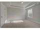 Bedroom featuring carpet, tray ceiling, natural light, and neutral paint at 4045 Andover Cir, Mcdonough, GA 30252