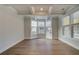 Bright, empty room featuring hardwood floors, white trim, tray ceiling, and lots of windows at 4045 Andover Cir, Mcdonough, GA 30252