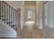 Inviting entryway with hardwood floors, staircase with iron railings, and lots of natural light at 4045 Andover Cir, Mcdonough, GA 30252