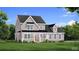 Charming two-story home with covered porch, landscaped yard, and craftsman-style details at 4045 Andover Cir, Mcdonough, GA 30252