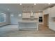 Bright kitchen with white cabinets, large island, stainless steel appliances, and hardwood floors at 4045 Andover Cir, Mcdonough, GA 30252