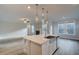 Modern kitchen island with white cabinetry, stone countertops, and pendant lighting in an open-concept living space at 4045 Andover Cir, Mcdonough, GA 30252