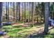 Backyard featuring a fire pit, storage shed, trampoline, and lush surrounding trees at 410 Killian Hill Sw Rd, Lilburn, GA 30047