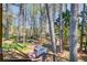 Lush backyard featuring mature trees, small garden shed, and open space perfect for outdoor activities at 410 Killian Hill Sw Rd, Lilburn, GA 30047