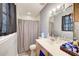 Functional bathroom with vanity, toilet, and shower/tub combo, offering essential amenities at 410 Killian Hill Sw Rd, Lilburn, GA 30047