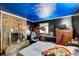Unique bedroom design with stone fireplace, blue painted ceiling, and black accent wall at 410 Killian Hill Sw Rd, Lilburn, GA 30047