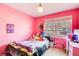 Colorful bedroom with a twin bed, natural light, and charming decor at 410 Killian Hill Sw Rd, Lilburn, GA 30047