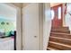 View of the entryway with hardwood stairs and a storage closet, leading to a bedroom at 410 Killian Hill Sw Rd, Lilburn, GA 30047