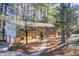 View of a two-story brick home with an attached garage and green shutters at 410 Killian Hill Sw Rd, Lilburn, GA 30047