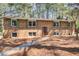 Charming two-story brick home with green shutters and a well-manicured front yard at 410 Killian Hill Sw Rd, Lilburn, GA 30047