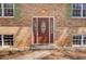 Close-up of the front door with decorative glass and brick surround at 410 Killian Hill Sw Rd, Lilburn, GA 30047