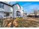 View of large backyard with fence, lawn, patio, and exterior of house featuring white siding and black trim at 6107 Waterton Dr, Lithonia, GA 30058