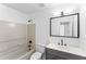 Bright bathroom featuring a tub/shower combination and a modern vanity at 6107 Waterton Dr, Lithonia, GA 30058