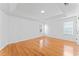 Spacious bedroom with gleaming hardwood floors, tray ceiling, and bright natural light at 6107 Waterton Dr, Lithonia, GA 30058