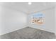 Cozy bedroom features soft gray carpet, tray ceiling, and ample natural light at 6107 Waterton Dr, Lithonia, GA 30058