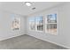 Bright bedroom with three windows and soft, neutral carpeting at 6107 Waterton Dr, Lithonia, GA 30058