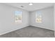 Bright bedroom with windows and soft, neutral carpeting at 6107 Waterton Dr, Lithonia, GA 30058