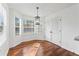 Bright breakfast nook featuring hardwood floors, large windows, and modern lighting at 6107 Waterton Dr, Lithonia, GA 30058